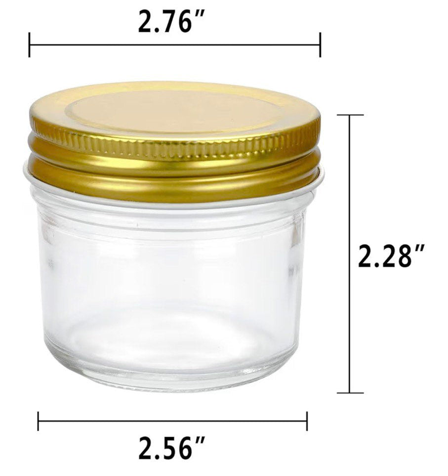 Clear glass jar with gold lid and dimensions on a white background